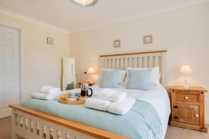 a bedroom with a bed with towels on it at Church Meadow Cottage in Trimingham