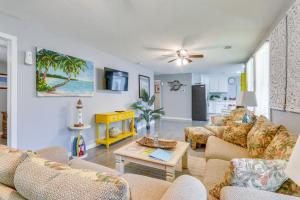 a living room with two couches and a table at Beachy Home in Heart of Beaufort with Pool Access in Beaufort