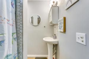 a bathroom with a sink and a mirror at Beachy Home in Heart of Beaufort with Pool Access in Beaufort +20 photos