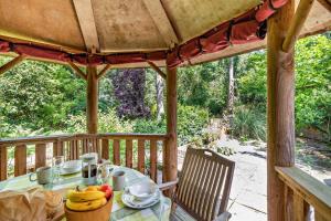 a table with bananas on it on a porch at Coach House Cottage in Wickham Market