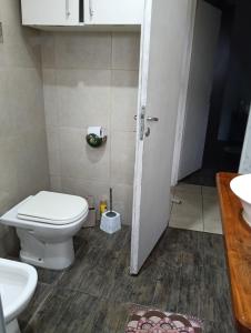 a bathroom with a toilet and a sink at Encasa in Gualeguaychú