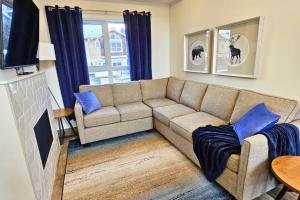 a living room with a couch and a table at Cloudline Vista 3 BdrmTownhouse with Garage managed by Little Sister Getaways in Canmore