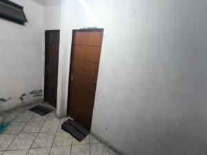 a room with two doors and a tiled floor at ADE Coj 23 LT 4 Ap102 in Brasília