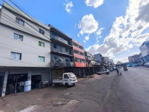 a street with a building and a car parked next to it at ADE Coj 23 LT 4 Ap102 in Brasília