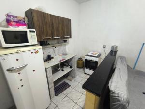 a kitchen with a white refrigerator and a microwave at ADE Coj 23 LT 4 Ap102 in Brasília