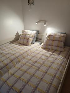 a bed with two pillows on it in a bedroom at La maison du verger in Magny-Fouchard