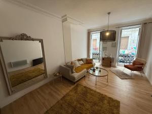 a living room with a couch and a large mirror at Bel appartement au centre ville de Carpentras in Carpentras