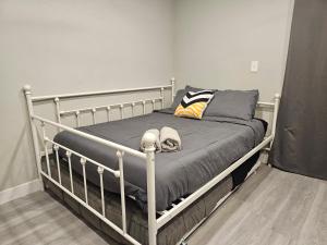 a white bed with a gray blanket and pillows at Gorgeous House & Loft Near Downtown in San Antonio