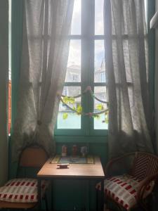 a table in front of a window with curtains at Old Tbilisi in Tbilisi City