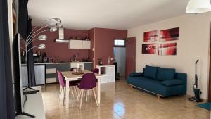a living room with a blue couch and a table at Studio indépendant au calme in Salvizinet