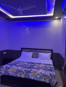 a bedroom with a large bed with a blue ceiling at Chaudhary Home Stay in Mathura