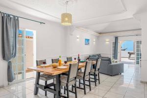 a dining room and living room with a table and chairs at Villa Venezuela by Villa Plus in Callao Salvaje
