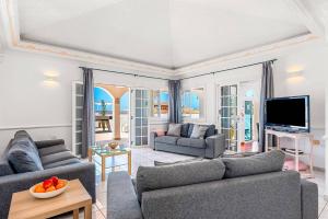 a living room with two couches and a tv at Villa Venezuela by Villa Plus in Callao Salvaje