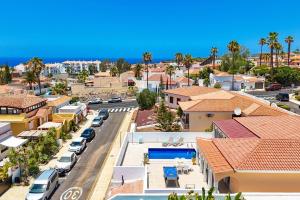 an aerial view of a town with cars parked at Villa Venezuela by Villa Plus in Callao Salvaje