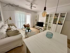 a living room with a couch and a table at Faro Bay in Estepona