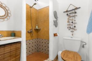 a bathroom with a toilet and a sink at BlueMoon Villa - Authentic, seaside living in Trou dʼ Eau Douce +31 photos
