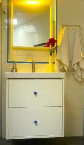 a bathroom with a white dresser and a mirror at 3 Bedroom Next to Airport & La Sagrada Familia Metro and FC barcelona Stadium in Hospitalet de Llobregat