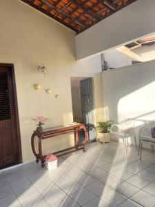 a room with a table and chairs on a tiled floor at Hostel da Dinda in São Luís