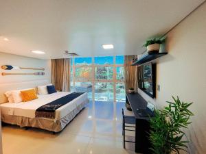 a bedroom with a bed and a large window at Luxo Frente Mar | Nobile #220 in Tambaú