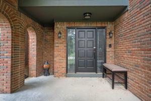 a front door of a brick house with a bench at The Gahanna Grand in Columbus