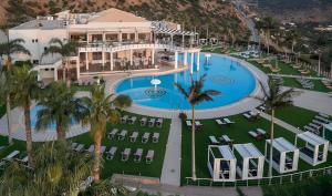 an aerial view of a resort with a swimming pool at The Noverian Scenic Crete 5 Star Hilltop Villa Resort & Spa in Malia