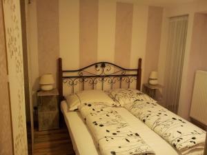 a bed in a bedroom with two lamps on tables at Villa Mondry in Bad Pyrmont