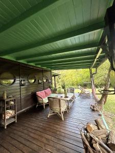 an outdoor deck with chairs and a green roof at Isla Chaná Private Hideaway in Buenos Aires