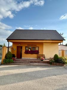 a building with a bench in front of it at Domček Lodenica in Šintava