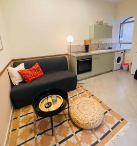 a living room with a couch and a table at Charming 1BR in Nachlaot Steps to the Shuk in Jerusalem