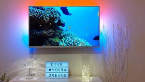 a flat screen tv on a wall with a aquarium at Mendys Sea View - Pomalo & Fjaka Retreat in Kaštela