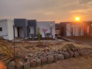 a building with a sunset in front of it at 1010 On The Edge in Mokhotlong