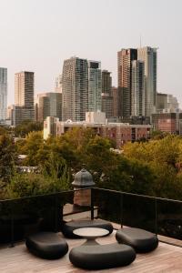 a view of a city from a balcony with benches at Maison Grinder in Montréal