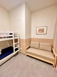 a room with two bunk beds and a couch at 3BR Gem Steps from Shuk Machne Yehuda in Jerusalem +6 photos