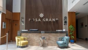 a lobby with two chairs and a sign that reads rosa grand at Rosa Grand Hotel in Riyadh