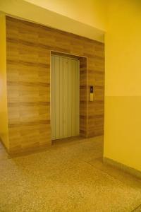 a door in a room with a wooden wall at Saki Nest Homes2 in Kisumu