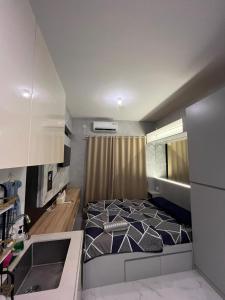 a bedroom with a large bed in a room at Apartment Sky House BSD By Moza Property in Cilenggang