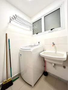 a bathroom with a toilet and a sink at Ocean View - Camboinhas Beach I 214B in Niterói +75 photos