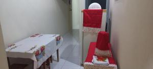 a room with red and white tables and chairs at Casa de Lagoa Nova in Martins