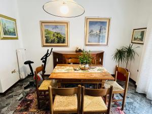 a dining room with a wooden table and chairs at Luxury Relax Apartment near Venice Station in Venice