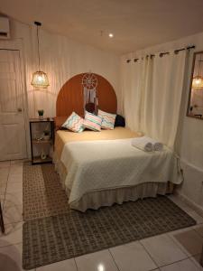 Un dormitorio con una cama con cabecero de madera. en Lina's Sunset and Surf, en La Libertad