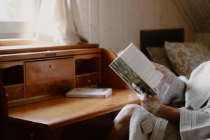 a person reading a book on a table at Casa Salino in Salino