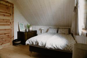 a bedroom with a bed and a wooden floor at Casa Salino in Salino