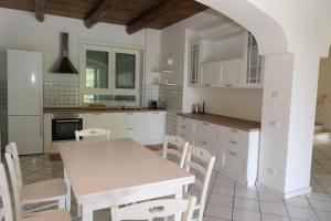 a kitchen with a table and chairs in a kitchen at The Wonder 400m from the Sea in Scario