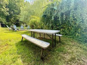 a picnic table and a bench in the grass at Town & Country Andover, NJ Area- Studio Unit in Newton