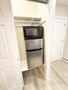 a kitchen with a microwave and a refrigerator at Town & Country Andover, NJ Area- Studio Unit in Newton