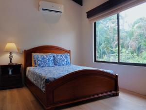 a bedroom with a bed and a large window at Casa Luz de Luna - Comfortable 3 Br, 3,5 Bath house in Potrero +63 photos