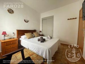 a bedroom with a bed with two stuffed animals on it at Faro28 in Valencia
