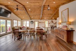a kitchen and dining room with a table and chairs at Fire Pit and Views Crooked Lake Group Getaway! in Averill Park