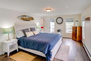 a bedroom with a bed and a clock on the wall at Fire Pit and Views Crooked Lake Group Getaway! in Averill Park