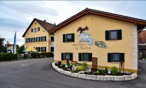 a building with a sign on the side of it at Landhotel Zum Adler in Oberbechingen